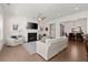 Bright and open living room with a fireplace, hardwood floors, and seamless connection to the dining area at 1074 Heyward Way, Alpharetta, GA 30009