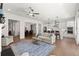 Spacious living room with hardwood floors, open layout to the kitchen, dining, and large windows at 1074 Heyward Way, Alpharetta, GA 30009