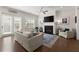 Bright living room with a fireplace, comfortable seating, and natural light from the sliding glass doors at 1074 Heyward Way, Alpharetta, GA 30009