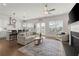 Open-concept living room with a fireplace, comfortable seating, and seamless flow to the kitchen and dining area at 1074 Heyward Way, Alpharetta, GA 30009