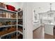 Walk-in pantry featuring ample shelving and storage space, conveniently located near the kitchen at 1074 Heyward Way, Alpharetta, GA 30009