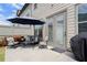 Inviting patio setup features a comfortable seating area, grill and access to the home through glass doors at 1074 Heyward Way, Alpharetta, GA 30009