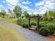 Cozy community swing under a pergola surrounded by lush landscaping and winding pathways at 1074 Heyward Way, Alpharetta, GA 30009