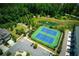Aerial view of community tennis courts with a view of the lake and beautiful landscaped areas at 1074 Heyward Way, Alpharetta, GA 30009