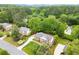 A beautiful home features manicured landscaping and long driveway among mature trees at 1328 Wyntercreek Rd, Atlanta, GA 30338