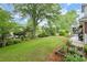 Beautiful backyard featuring a manicured lawn, mature trees, and charming swing set at 1328 Wyntercreek Rd, Atlanta, GA 30338