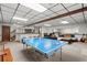 Finished basement featuring a ping pong table, wet bar, and sectional sofa at 1328 Wyntercreek Rd, Atlanta, GA 30338