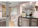 Bathroom featuring double vanity, granite counters, frameless shower and shuttered window at 1328 Wyntercreek Rd, Atlanta, GA 30338