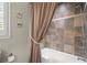 Bathroom featuring combination shower and tub, tile surround and linen closet at 1328 Wyntercreek Rd, Atlanta, GA 30338