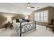 Bedroom with neutral colors, ceiling fan, shuttered windows, and wrought iron bed frame at 1328 Wyntercreek Rd, Atlanta, GA 30338