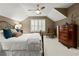 Bedroom featuring neutral colors, ceiling fan, shuttered windows, and wrought iron bed frame at 1328 Wyntercreek Rd, Atlanta, GA 30338