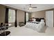 Bedroom with ceiling fan, shuttered windows, and decorative accents at 1328 Wyntercreek Rd, Atlanta, GA 30338