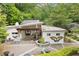 Aerial view of building with butterfly mural on exterior walls, outdoor patio seating, and lush green landscaping at 1328 Wyntercreek Rd, Atlanta, GA 30338