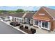 Exterior view of commercial building with storefronts and outdoor patio seating and mature trees at 1328 Wyntercreek Rd, Atlanta, GA 30338