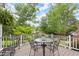 Deck offering outdoor dining with a table and chairs, complemented by beautiful landscaping at 1328 Wyntercreek Rd, Atlanta, GA 30338