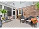 Outdoor seating on a wooden deck, surrounded by brick walls and lush landscaping at 1328 Wyntercreek Rd, Atlanta, GA 30338