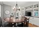 Dining room featuring a wooden table set, chandelier, and built-in cabinets at 1328 Wyntercreek Rd, Atlanta, GA 30338