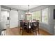 Bright dining area with wood floors, a round table, and a barn door at 1328 Wyntercreek Rd, Atlanta, GA 30338