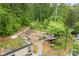 An aerial shot of a unique outdoor classroom featuring stone paths, covered structure, and a green roof with vegetation at 1328 Wyntercreek Rd, Atlanta, GA 30338
