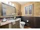 Charming half bathroom featuring granite countertops, wallpaper, and decorative lighting at 1328 Wyntercreek Rd, Atlanta, GA 30338