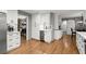 An open kitchen with white cabinets, a beverage cooler, and wood flooring at 1328 Wyntercreek Rd, Atlanta, GA 30338
