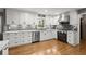 Modern kitchen with stainless steel appliances, white cabinets, and hardwood floors at 1328 Wyntercreek Rd, Atlanta, GA 30338