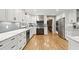 Spacious kitchen featuring white cabinets, stainless steel appliances, and hardwood floors at 1328 Wyntercreek Rd, Atlanta, GA 30338
