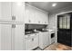 Laundry room featuring a washing machine, dryer, and white cabinets at 1328 Wyntercreek Rd, Atlanta, GA 30338