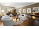 Charming living room features stylish decor, a piano, and an open doorway to the foyer at 1328 Wyntercreek Rd, Atlanta, GA 30338