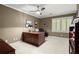 Office features a ceiling fan, natural light, and a large desk at 1328 Wyntercreek Rd, Atlanta, GA 30338