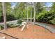 Aerial view of a neighborhood playground with swings and slide surrounded by mature trees and well-maintained landscaping at 1328 Wyntercreek Rd, Atlanta, GA 30338
