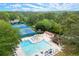 Aerial view of a community pool, tennis courts and gathering areas surrounded by beautiful mature trees and foliage at 1328 Wyntercreek Rd, Atlanta, GA 30338