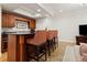 Finished basement featuring a bar with dark countertops, seating, and wooden cabinetry at 1658 Mount Paran Nw Rd, Atlanta, GA 30327