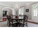 Elegant dining room features wood floors, chandelier, a table with seating for six, and arched entry at 1658 Mount Paran Nw Rd, Atlanta, GA 30327