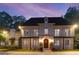 Elegant multi-story home featuring a striking brick facade and classic architectural details at twilight at 1658 Mount Paran Nw Rd, Atlanta, GA 30327