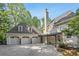 Charming home with a large garage, well-maintained landscaping, and a circular driveway at 1658 Mount Paran Nw Rd, Atlanta, GA 30327