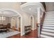 Spacious foyer featuring wood floors, staircase and dining room visible through an arched doorway at 1658 Mount Paran Nw Rd, Atlanta, GA 30327