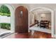 Home foyer features wood floors and a dining room visible through an arched doorway with chandelier at 1658 Mount Paran Nw Rd, Atlanta, GA 30327