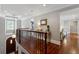 Hallway with hardwood floors, iron railing, and plenty of natural light, leading to various rooms at 1658 Mount Paran Nw Rd, Atlanta, GA 30327