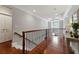 Upstairs landing featuring hardwood floors, decorative railing, and natural light at 1658 Mount Paran Nw Rd, Atlanta, GA 30327