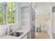 Bright, all-white kitchen with stainless appliances and views out of the large window at 1658 Mount Paran Nw Rd, Atlanta, GA 30327