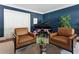 Cozy living room with a piano and leather chairs positioned around a modern coffee table with plant at 1658 Mount Paran Nw Rd, Atlanta, GA 30327