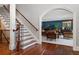 Sitting room features staircase, wood floors and navy blue accent wall with a piano and seating area at 1658 Mount Paran Nw Rd, Atlanta, GA 30327