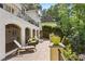 Outdoor patio featuring stone flooring, lounge chairs, lush greenery, and exterior archways at 1658 Mount Paran Nw Rd, Atlanta, GA 30327