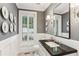 Charming powder room featuring decorative wall plates, wainscoting, and black marble countertop at 1658 Mount Paran Nw Rd, Atlanta, GA 30327