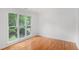 Bedroom featuring large windows with views of the wooded lot and hardwood flooring throughout at 1721 Druids Se Xing, Conyers, GA 30013