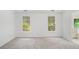 Carpeted bedroom with light and airy feel due to the neutral colored walls, windows and door to bathroom at 1721 Druids Se Xing, Conyers, GA 30013