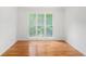 Bedroom with natural light shining through a large triple window and hardwood flooring throughout at 1721 Druids Se Xing, Conyers, GA 30013