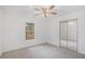 Bright bedroom with neutral carpet, closet with mirrored doors and window view at 1721 Druids Se Xing, Conyers, GA 30013
