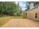 Backyard wooden deck with trees and house exterior at 1721 Druids Se Xing, Conyers, GA 30013